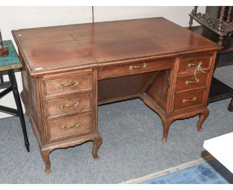 A Mahogany Kneehole Desk, early 20th century, the metamorphic central section housing an Underwood No. 5 typewriter, with six
