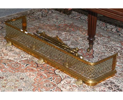 A Pierced Brass Fire Curb, a pair of andirons and a set of fire tools