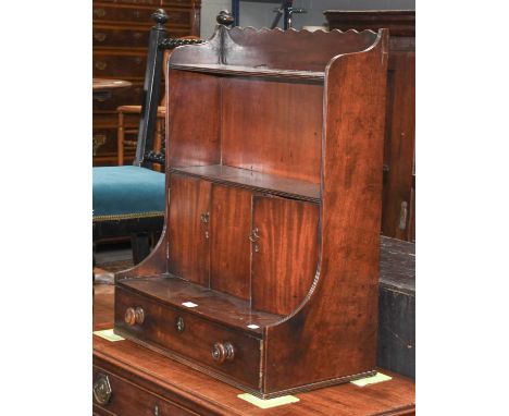 A 19th Century Mahogany Wall Shelf, the two shelf tiers above three cupboard doors over a base drawer, with turned handles an