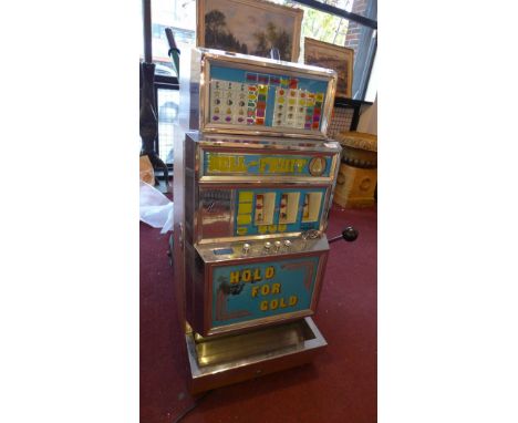 A 1970's 'Hold for Gold' vintage one arm bandit arcade slot machine. 