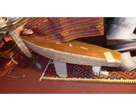 A vintage model of a boat with keel