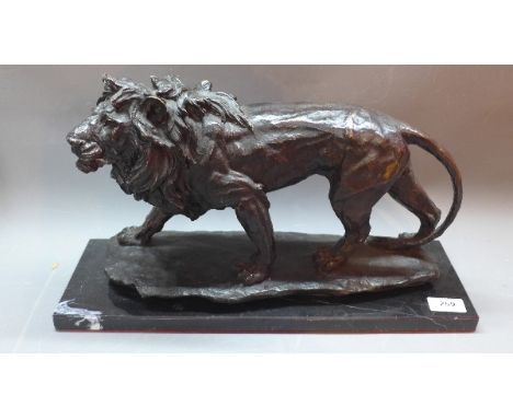 A bronze sculpture in the form of a lion on black marble plinth. L: 45cm