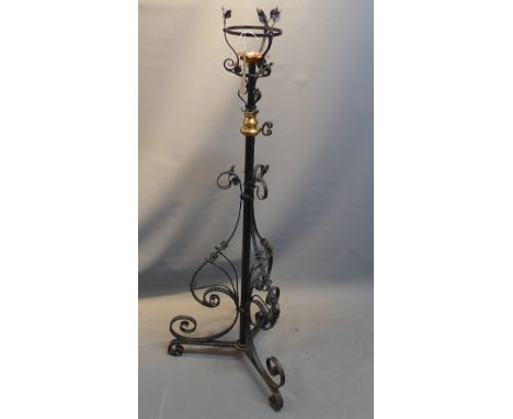 An early 20th Century wrought iron standard lamp. 