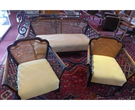 An Edwardian three piece suite with cane design (two seat sofa and 2 chairs)