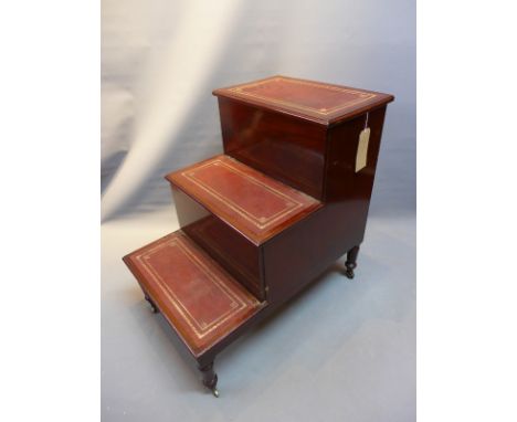 A set of early 20th Century mahogany library steps with pull out commode. 