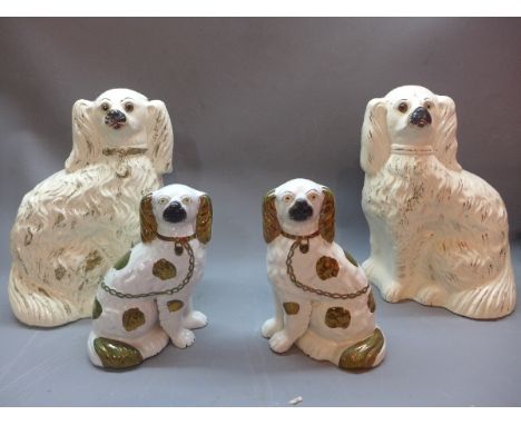 A pair of Staffordshire dogs together with a smaller companion pair