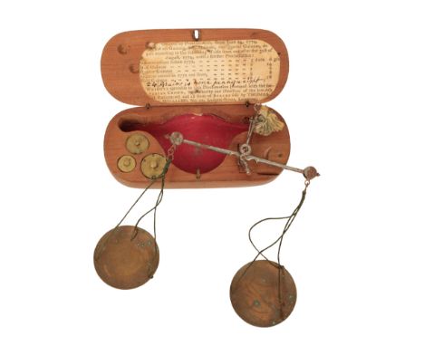 A GUINEA BALANCE by Thomas Williams, London, c.1774, the steel beam with articulated ends, two brass pans and a tassel to sus