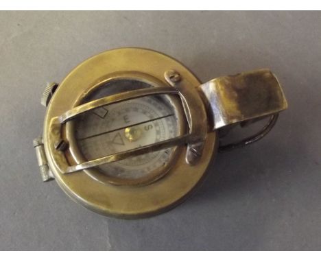 A brass military compass marked 'T & G Co. London, 1943, Mk II', 2¼'' diameter