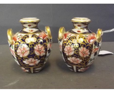 A pair of small C19th Derby style twin handled porcelain vases in the Imari palette, marked, 3¼'' high