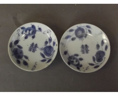 A pair of C19th Chinese porcelain dishes with blue and white decoration of fruit and calligraphy, 3½'' diameter