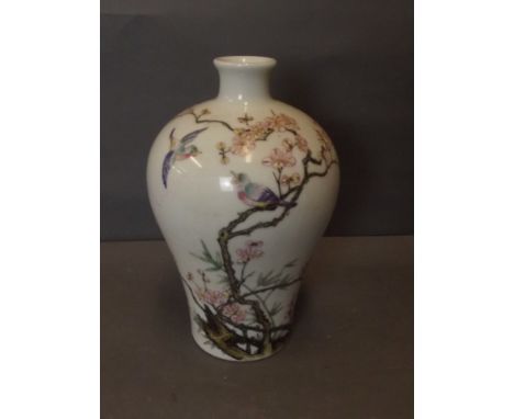 An early C20th Chinese baluster shaped porcelain vase with painted enamel decoration of exotic birds perched on a blossom bra