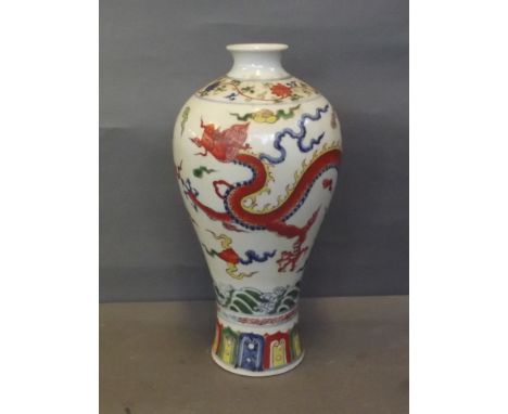 A Doucai baluster vase painted with dragon chasing the flaming pearl, 12½'' high