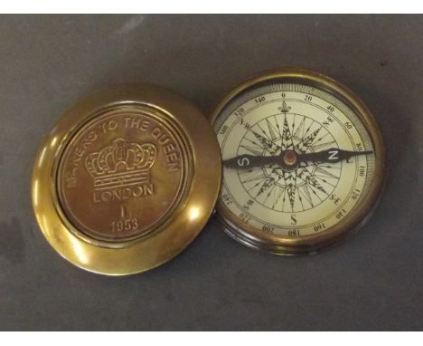 A brass cased pocket compass marked 'Makers to the Queen', London 1953, 3'' diameter