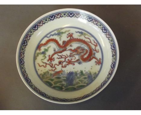 A Doucai dish decorated with a dragon chasing the flaming pearl and bats by water, 6 character mark, 7¼'' diameter