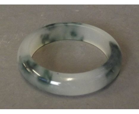 A bi-colour jade bangle, 3¼'' diameter