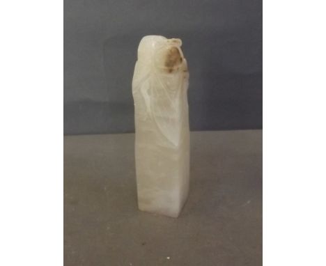 A white jade seal carved with a locust, inscribed with characters verso, 5½'' high