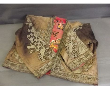 A C19th Ottoman short jacket of worn velvet, with fine silver thread brocade decoration