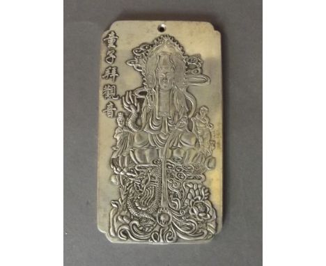 A Chinese white metal token decorated with Quan Yin relief, a dragon chasing the flaming pearl, and character inscription, 2 