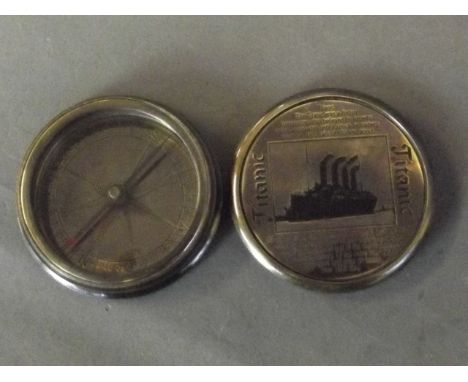 A contemporary brass compass decorated with the Titanic with inscriptions, 2¼'' diameter