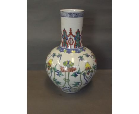 An early Chinese porcelain vase with Doucai enamel decoration of flowers, 6 character mark, 16¼'' high