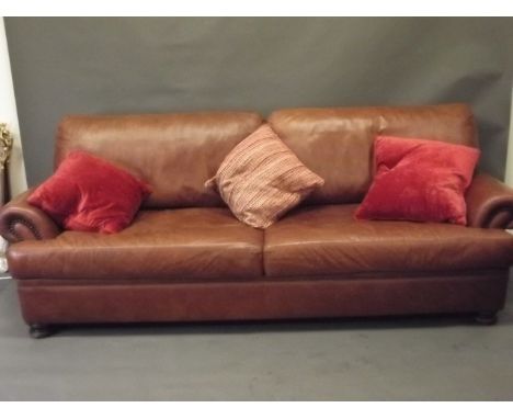 A large John Lewis three-to-four seater sofa in tan leather, 90'' x 39'', 33'' high