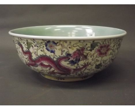 A large Chinese porcelain bowl with enamel decoration on an incised yellow ground of dragons, phoenix and trailing flowers, s