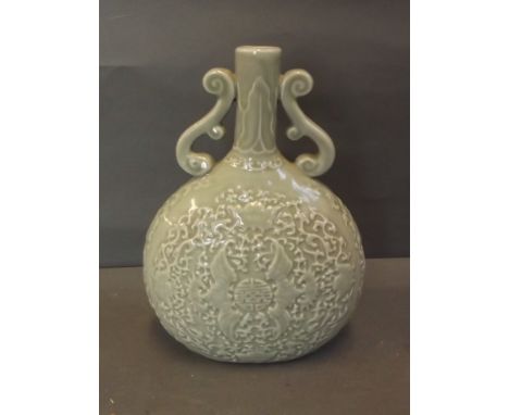 A Chinese celadon ground twin handled moon flask with relief bat and character decoration, marked, 9½'' high