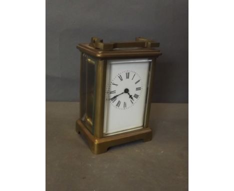A brass carriage clock with enamel dial and Roman numerals, 4½'' high