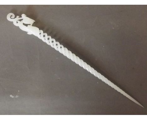 A Chinese white jade pierced hairpin with spiral decoration and a carved dragon head handle, 9¼'' long