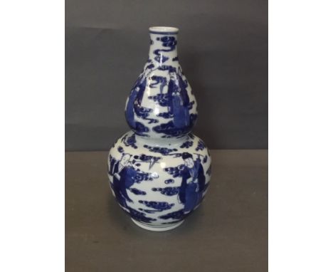 A C19th Chinese blue and white double gourd porcelain vase depicting the Eight Immortals stood upon clouds, 4 character mark,