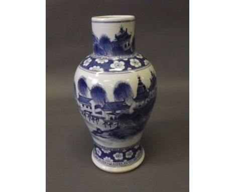 An C18th Chinese blue and white porcelain baluster vase with painted village landscape decoration, and cracked ice and prunus