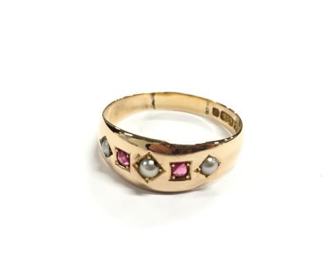 A 15 carat gold seed Pearl and Ruby ring.
(R1)