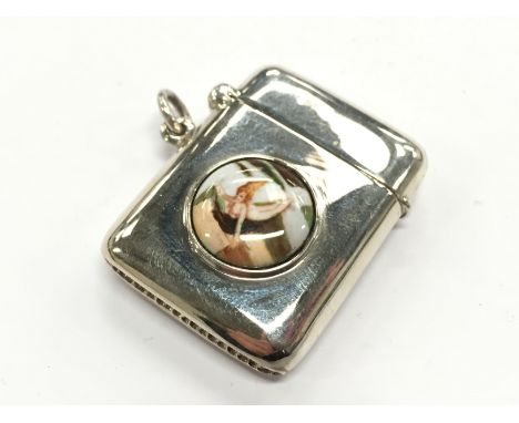 A silver and enamel effect Vesta case decorated with a naked female figure.