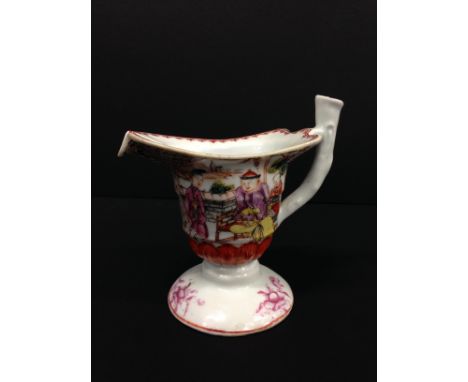 A Cantonese Export helmet shaped cream jug with twig handle decorated with figures in interior settings on balcony, on circul