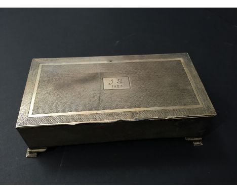 An early 20th century engine turned silver cigarette box together with a silver compact.