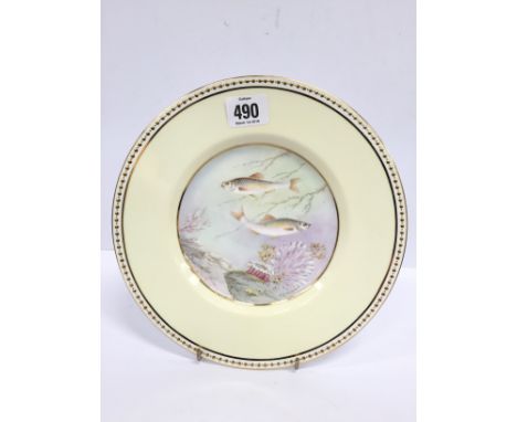 An early 20th century hand painted porcelain dessert plate, decorated with swimming fish in undersea setting by F. R. Navney.
