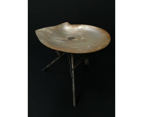 An Eastern silver and mother of pearl fruit stand resting on cross legged bamboo effect silver supports.