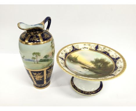 A Noritake china large porcelain jug decorated with a church by river with gilded blue enamel lower decoration together with 