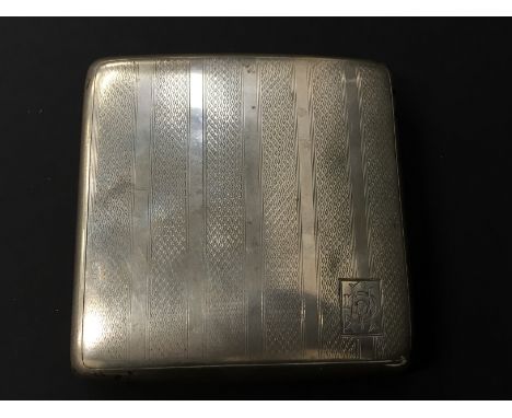 An engine turned silver concave cigarette case (110 grams overall).
