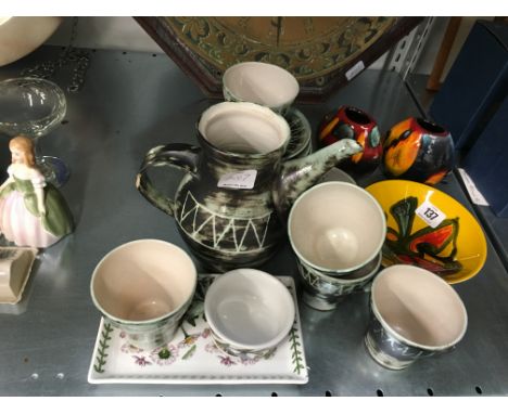 The residue of an Art Pottery coffee service together with three Poole Pottery items and other china.