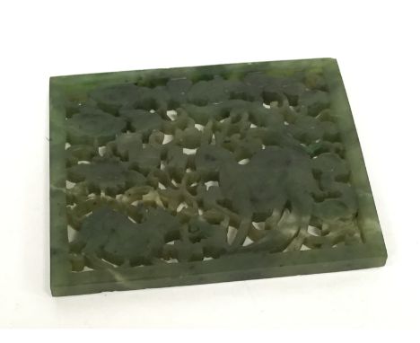 A small pierced jade panel decorated with animals and fauna (7cm x 5.5cm).