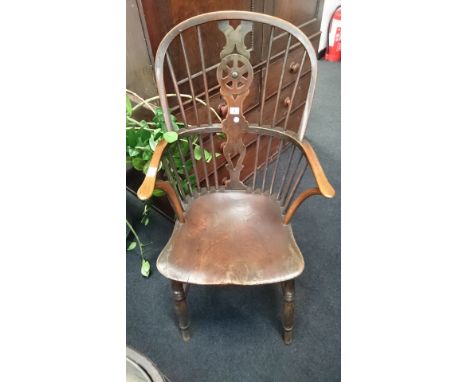 A stick back oak framed wheelback Windsor chair with elm seat, resting on turned tapered supports to front.