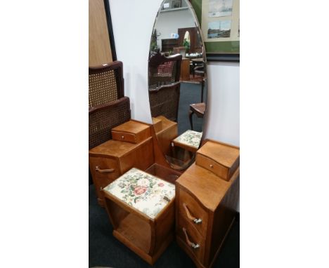 A low oak Art Deco dressing table with large bevel edged dressing mirror to back and small glazed shelf below with four shape