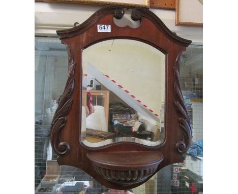 A mirror with display shelf