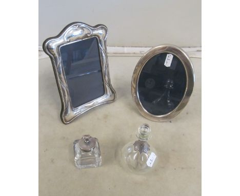 Two silver photo frames, inkwell and scent bottle