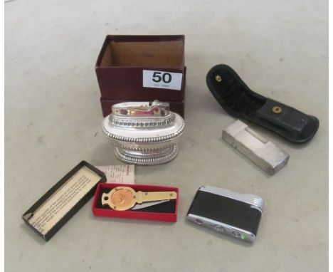 A Pierre Cardin lighter, Dunhill white metal lighter (in original case), boxed Ronson and boxed farthing penknife