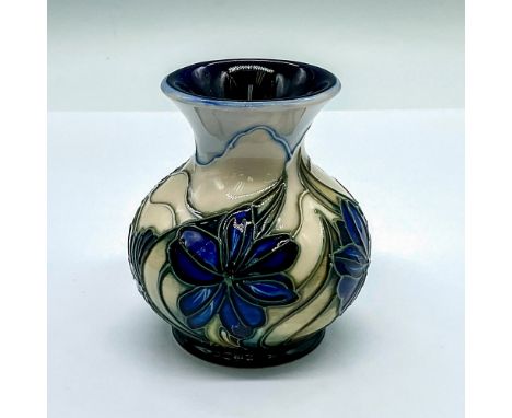 A small white ground vase with blue flowers in excellent tube lining. Moorcroft and artists' marks. This item has its origina