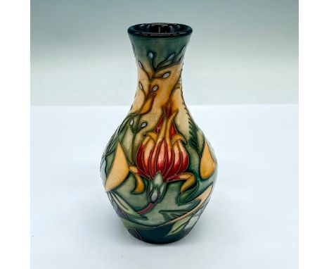 A small vase with stunning detailed tube lining of exotic flowers. Moorcroft marking on the base. Artist's marks on the under