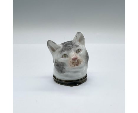 A ceramic sculpted head of a white cat with gray spots. Placed on a brass bottom with embossed details. Samson mark on the in