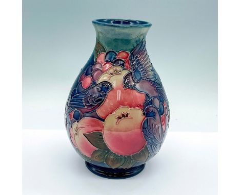 A blue vase depicting blue finches over berries. Excellent tube lining. Moorcroft marked. Artist marked. This item has its or